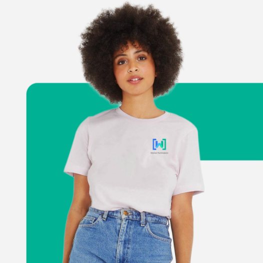 A woman with an afro wearing a white t-shirt with the WTM logo stands casually, with a teal background element.